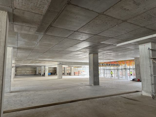 Interior view of a completed structural floor, looking across open bays